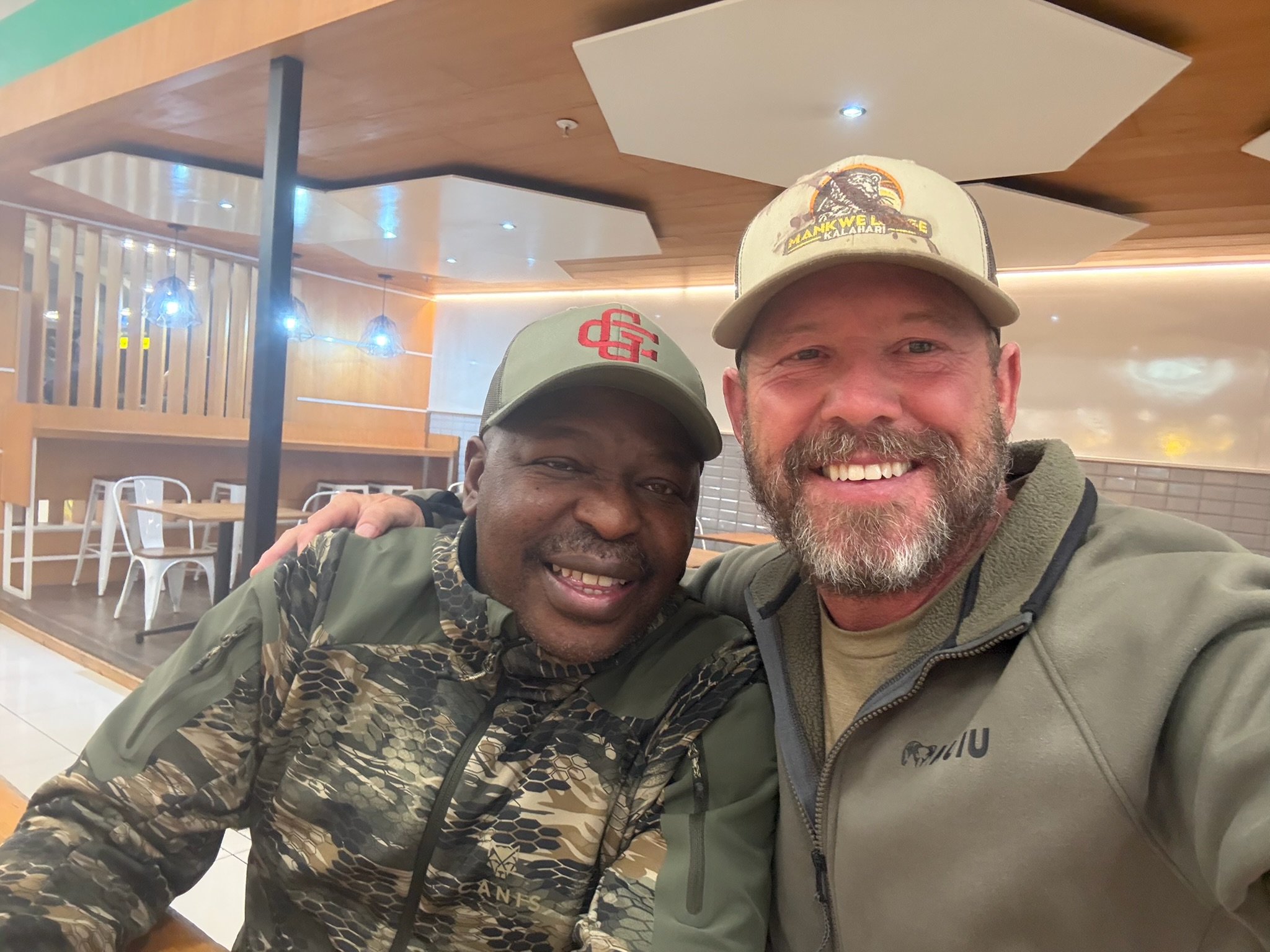 Mankwe hosts smiling together indoors