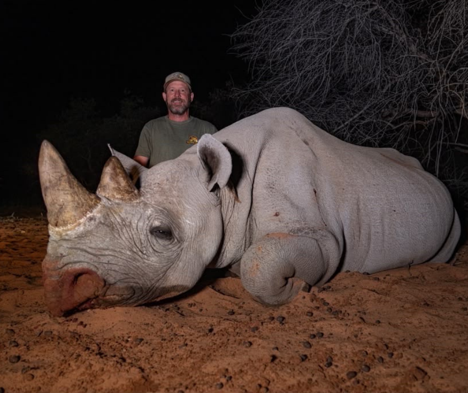 Robert Beall with a black rhino at night